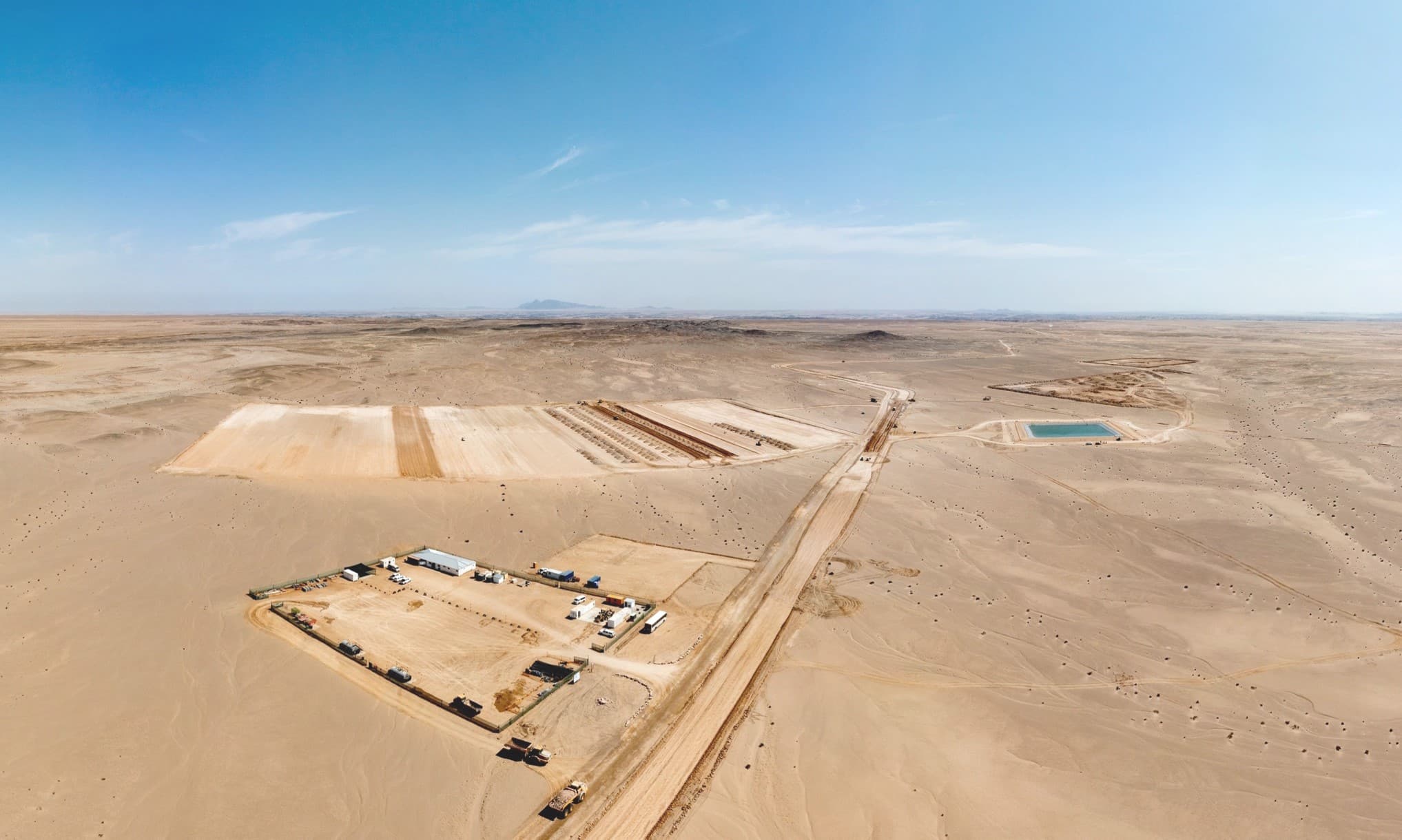 Aerial view of the Etango uranium project site in Namibia's Erongo Region, with cleared earthworks pads and a water pond