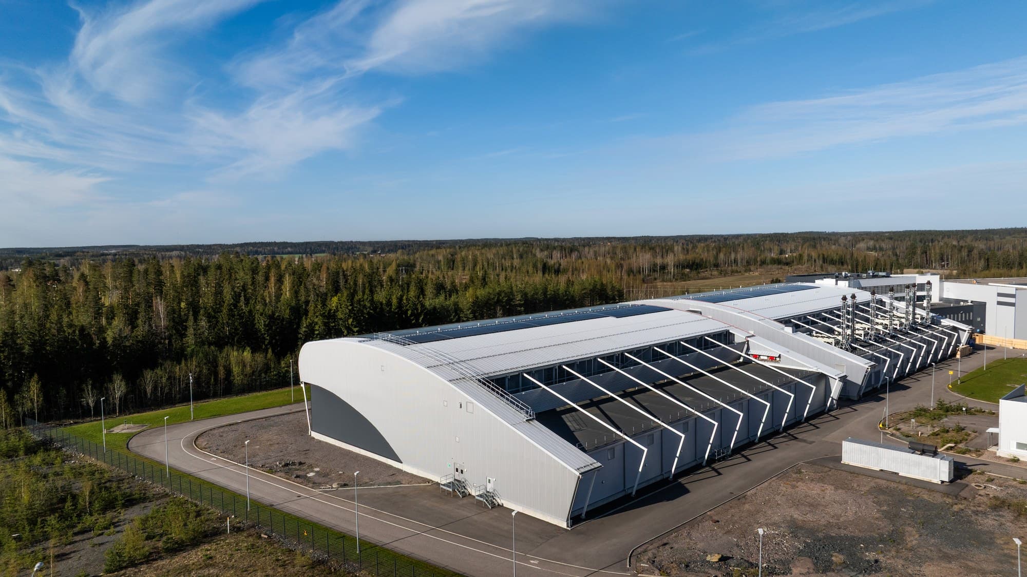Aerial view of a Nebius AI data center hall in Finland, set among forest