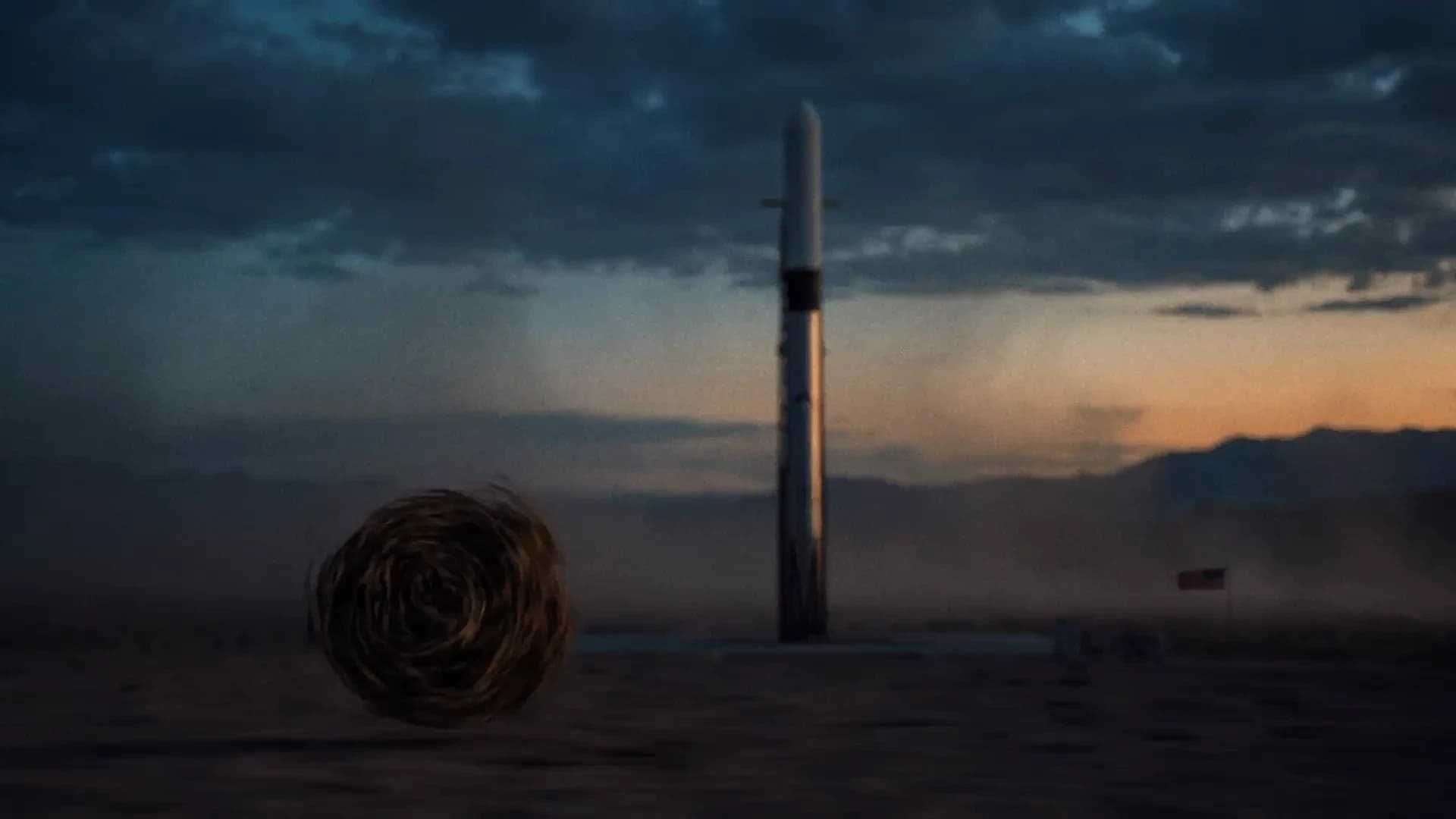 Launch vehicle standing on a desert pad at dusk with a tumbleweed in the foreground, a Cowboy Space promotional still