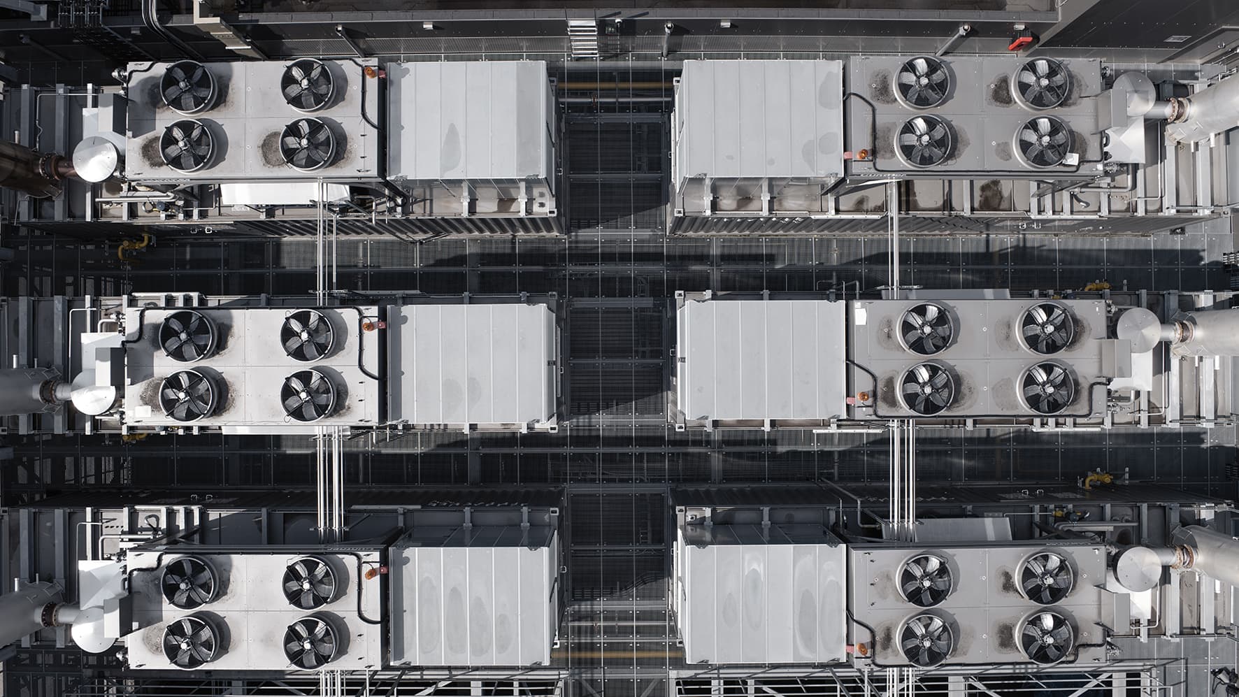 Overhead view of rows of containerized INNIO Jenbacher gas engine units with cooling fans at a data center power site