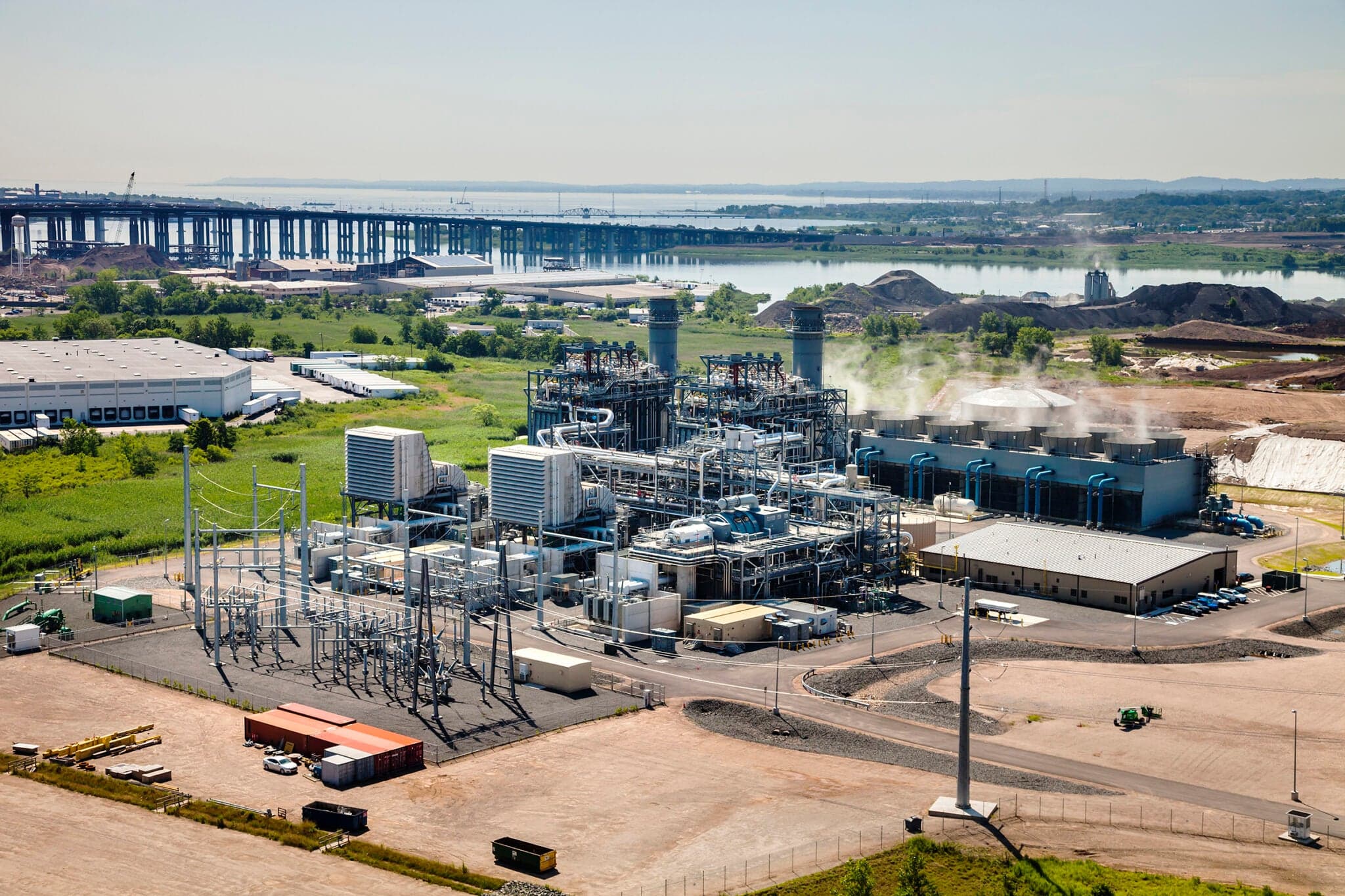 Aerial view of the CPV Woodbridge Energy Center, a gas-fired combined-cycle power plant with two exhaust stacks, a cooling tower and a switchyard in Woodbridge Township, New Jersey