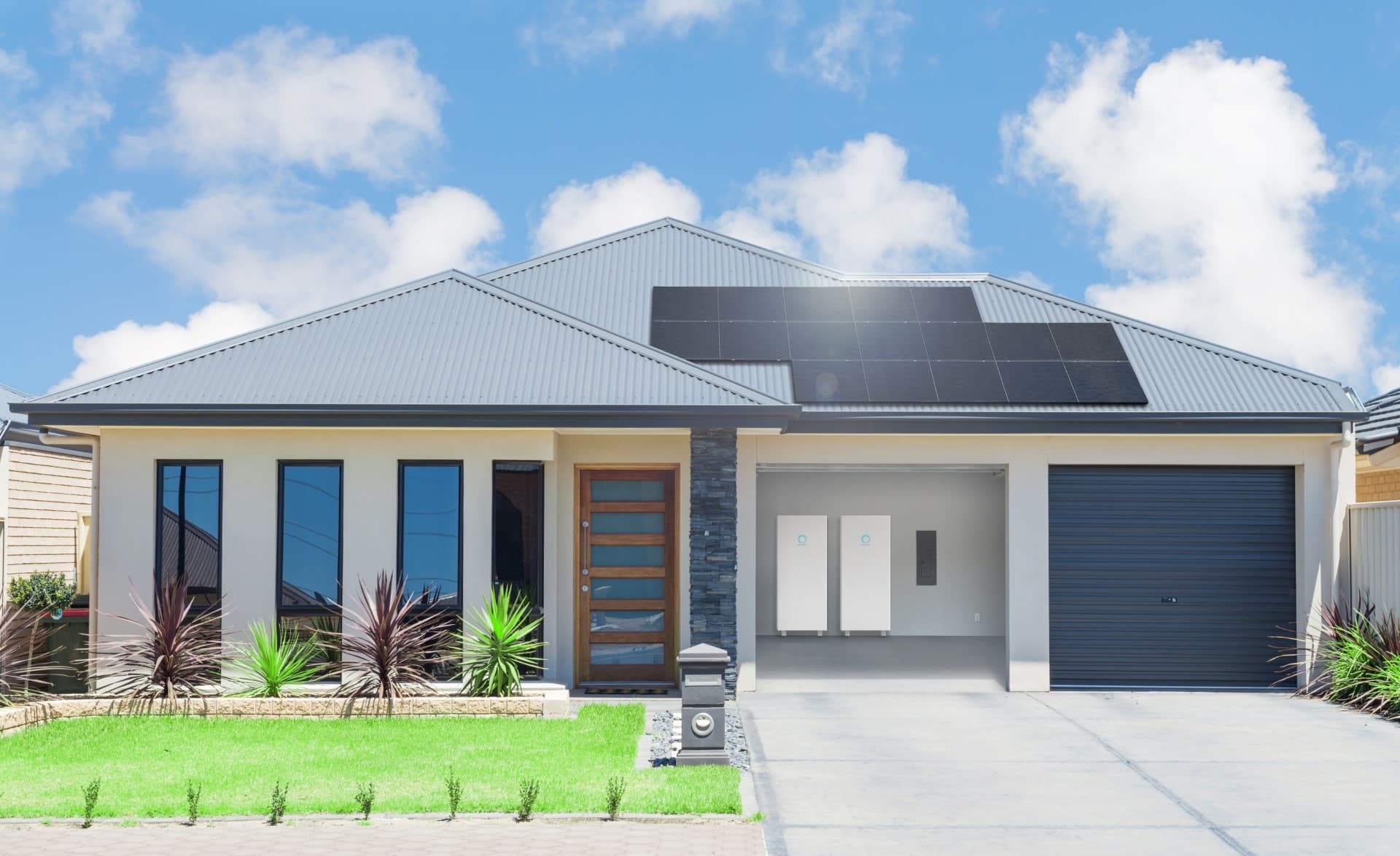 Two white sonnen home battery units mounted in a house garage under a rooftop solar array, shown on sonnen USA's press page