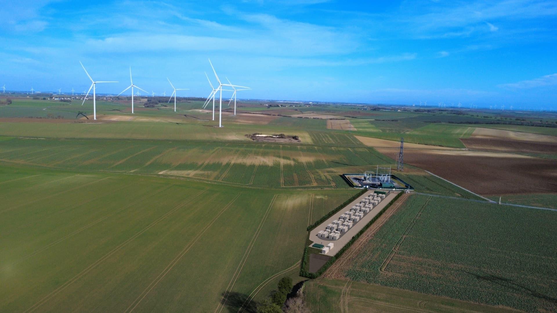 Aerial view of the planned Les Sablons battery storage site beside wind turbines in Hauts-de-France, Enertrag