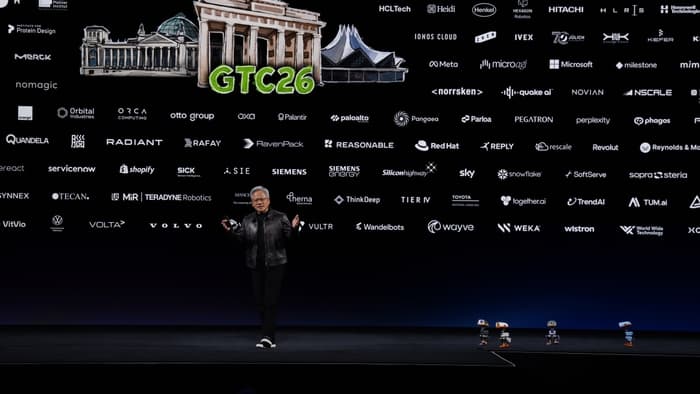 NVIDIA CEO Jensen Huang on stage at the GTC Berlin keynote in front of a wall of partner logos