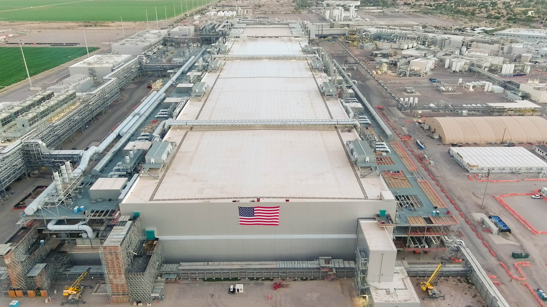 Aerial view of Intel's Fab 62 building at the Ocotillo campus in Arizona, with an American flag hung on its wall