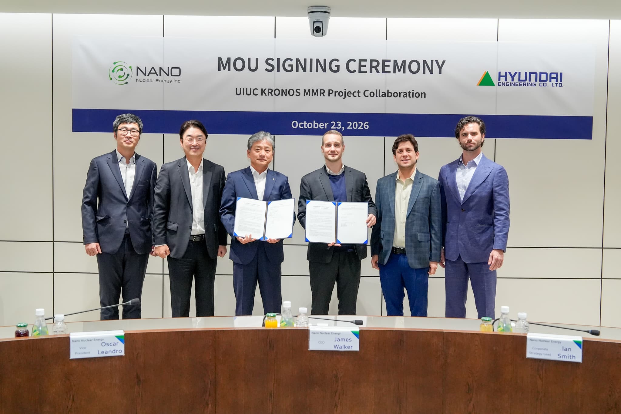 Six executives from NANO Nuclear Energy and Hyundai Engineering stand in front of an MoU signing ceremony banner for the UIUC KRONOS MMR project, two of them holding the signed agreement folders.