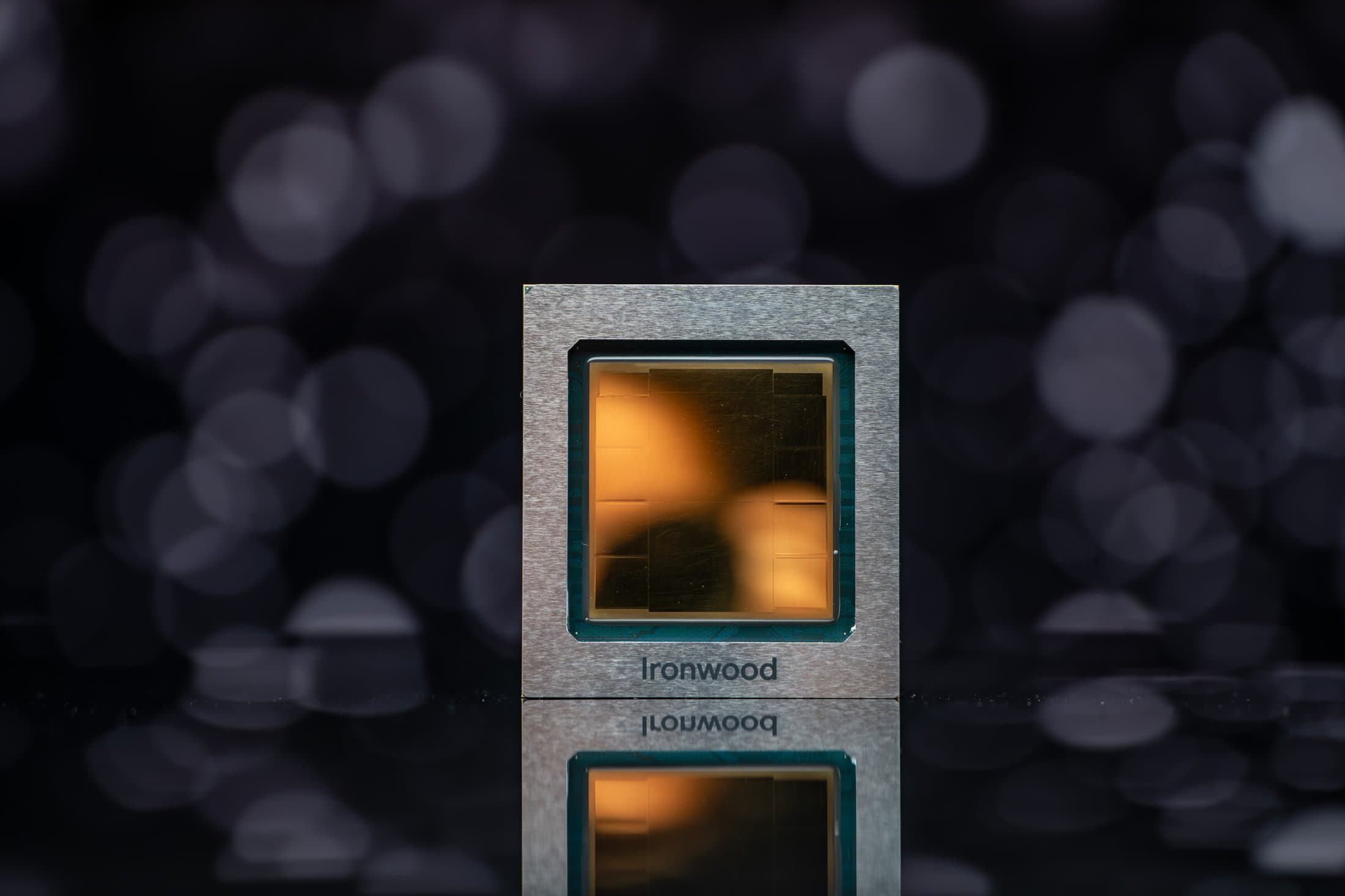Google Ironwood TPU chip package with the name Ironwood on its metal frame, photographed against a dark background