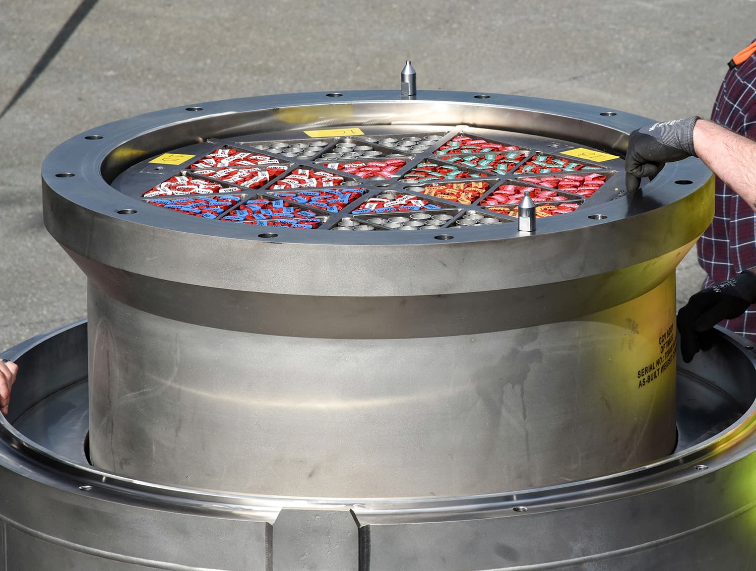Open stainless-steel fuel shipping container with trays of nuclear fuel components, from BWXT's Antares TRISO fuel announcement