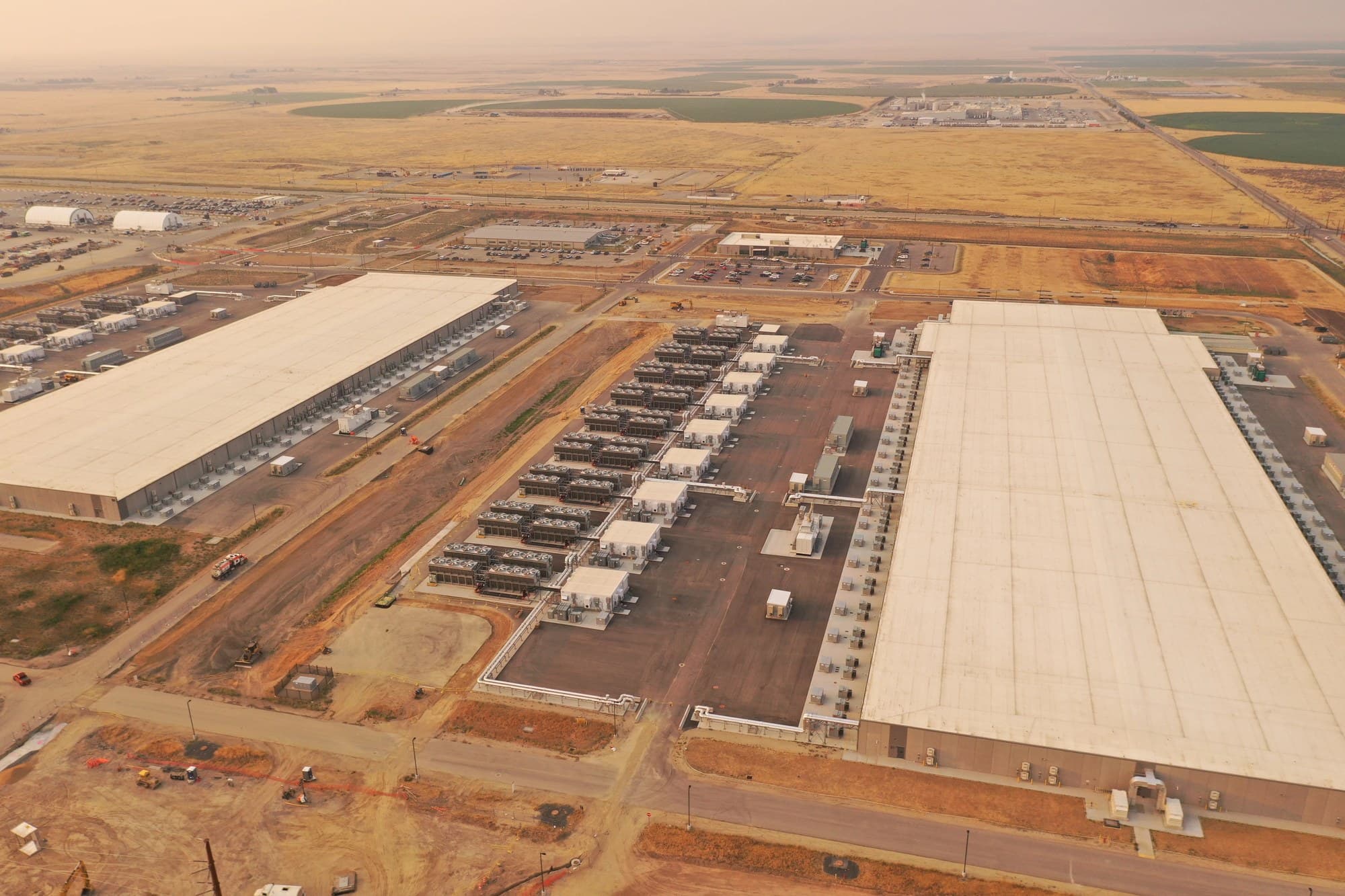 Aerial view of Meta's data center campus in Kuna, Idaho, with two large white-roofed halls and rooftop cooling equipment