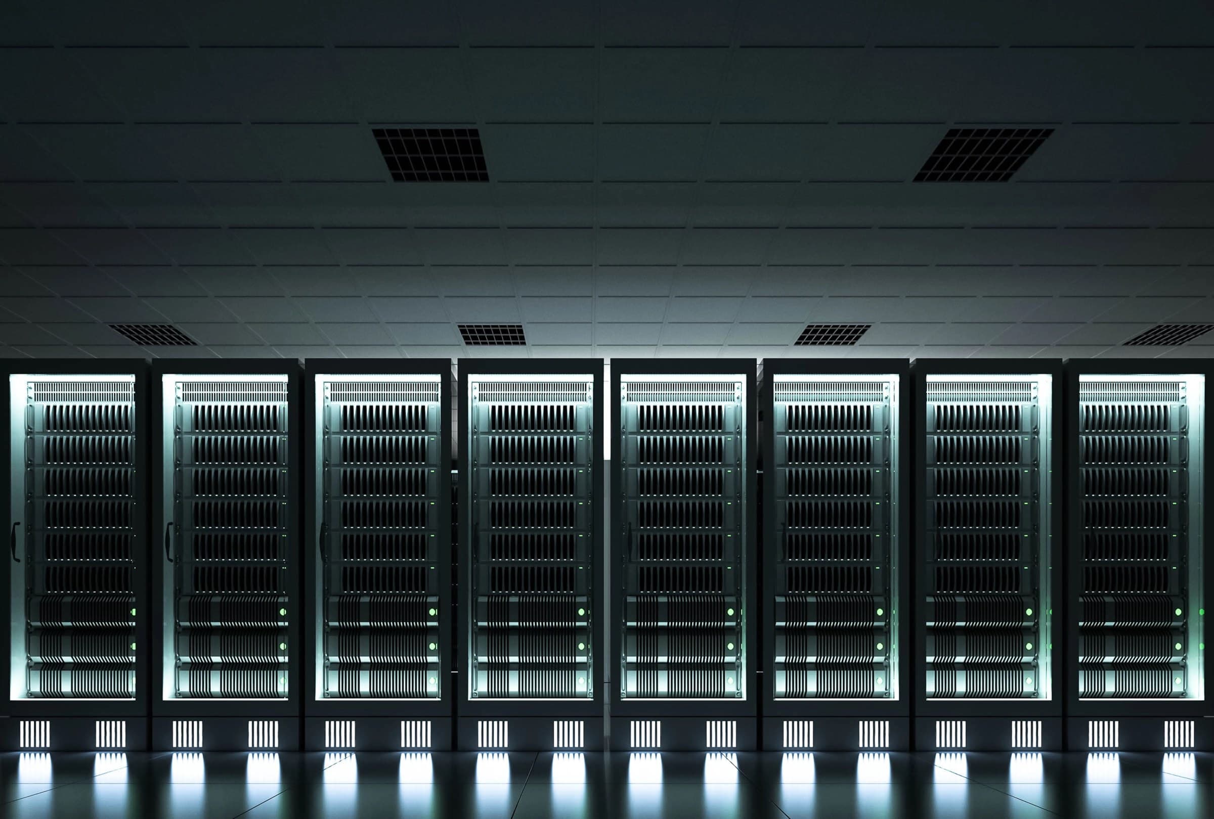 Rows of illuminated server racks in a dark data hall, an image from the Aolani website