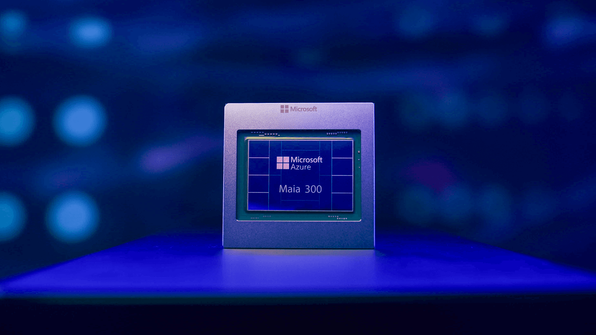Microsoft Azure Maia 300 custom AI chip package on a blue-lit stand, from Microsoft's newsroom