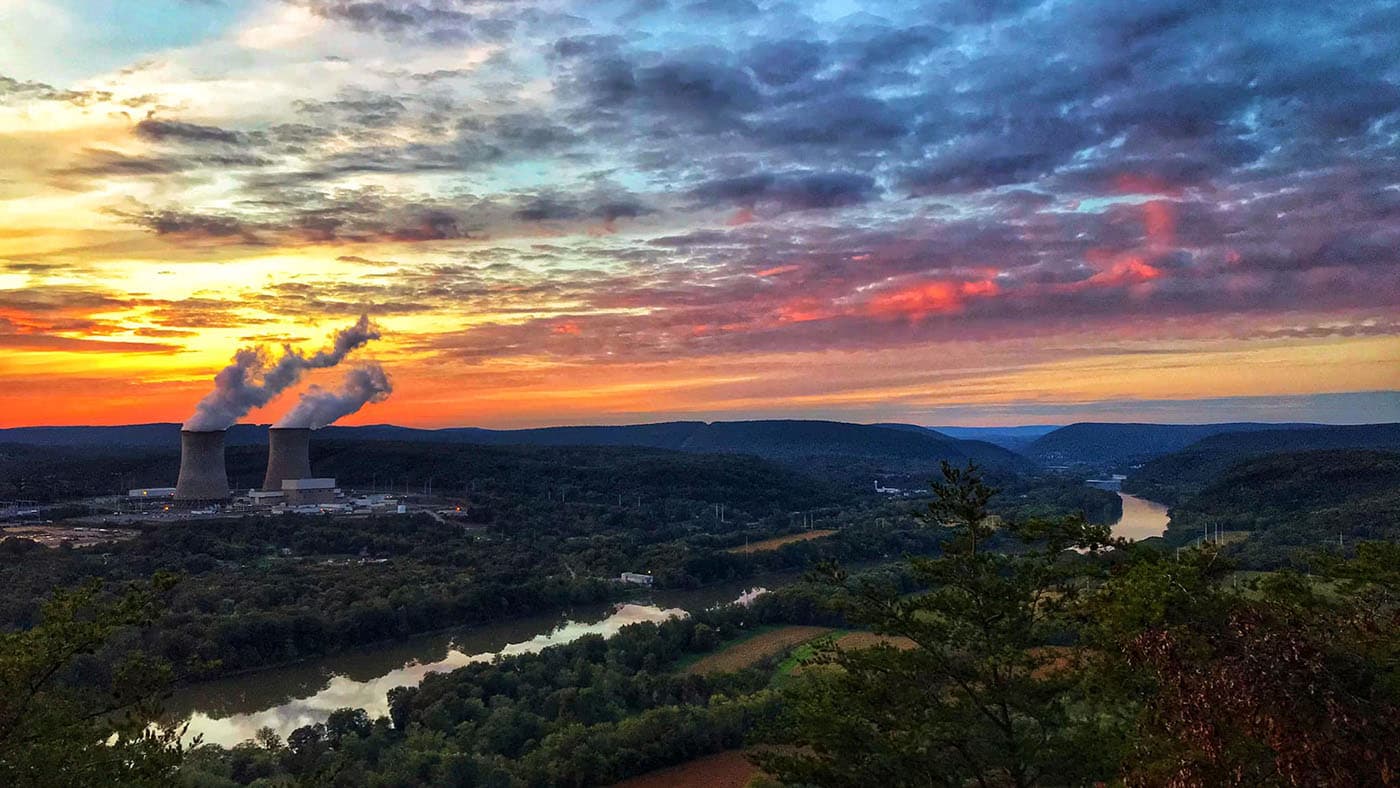 Susquehanna nuclear plant cooling towers with steam plumes at sunset above the Susquehanna River valley, Pennsylvania