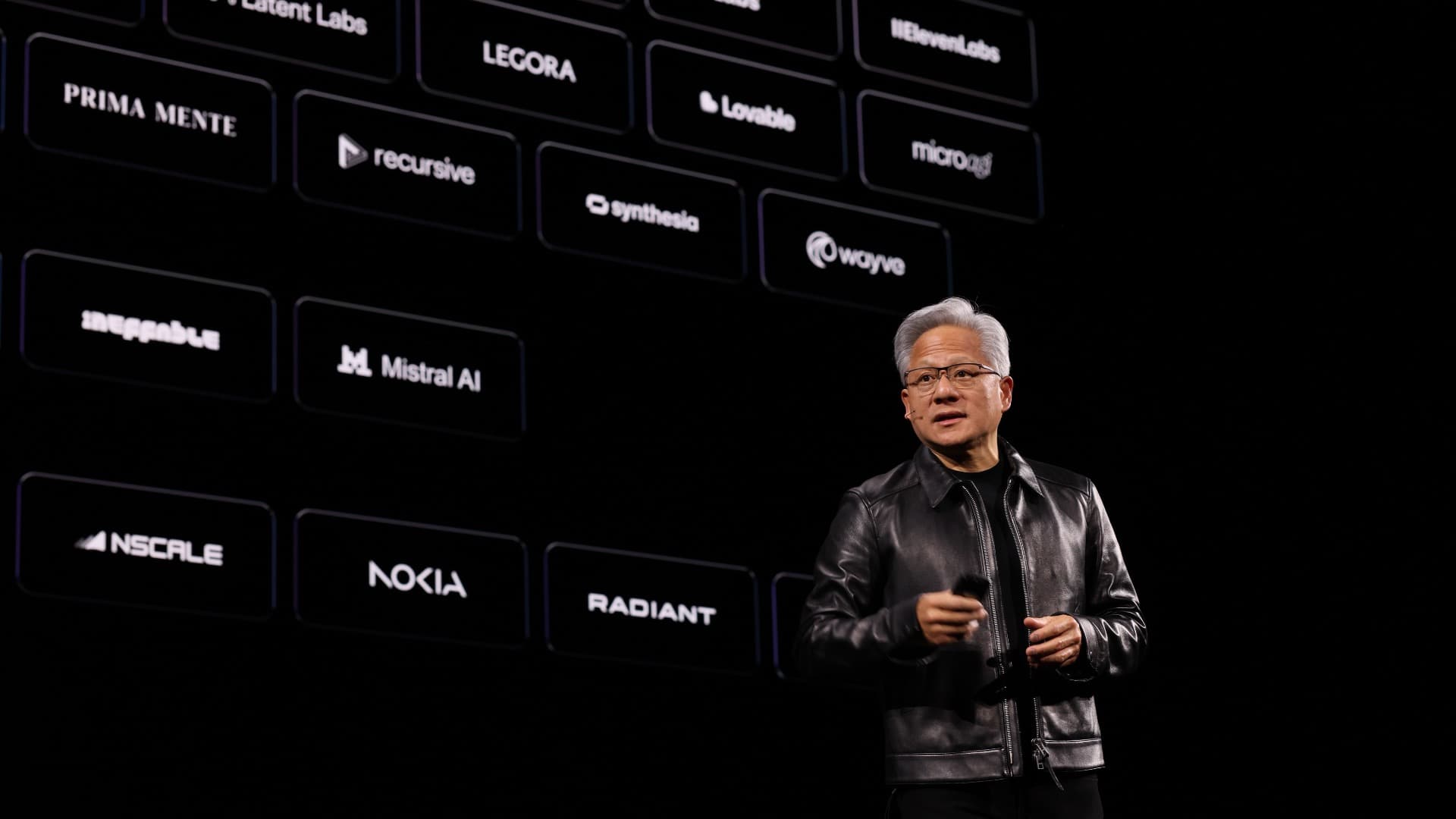 Jensen Huang, NVIDIA CEO, speaking on stage at the GTC Berlin keynote in front of a wall of partner logos