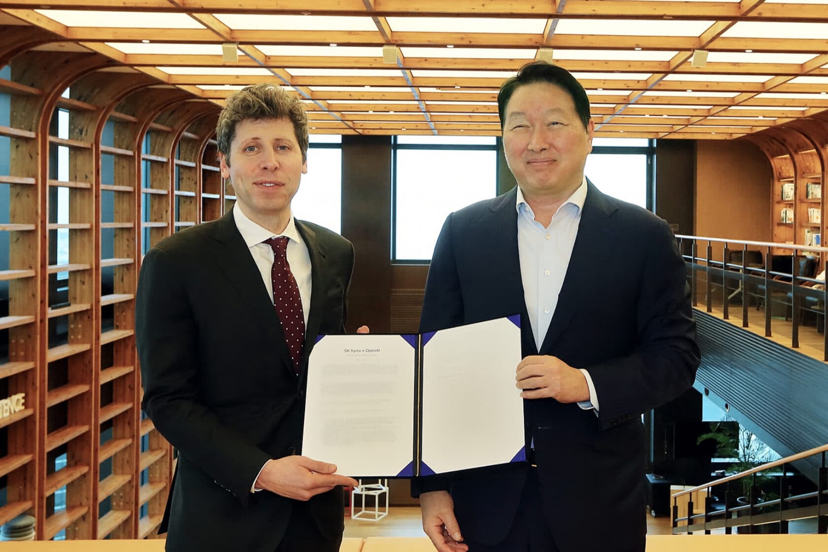 Sam Altman, OpenAI CEO, and SK Group Chairman Chey Tae-won hold an SK hynix x OpenAI document