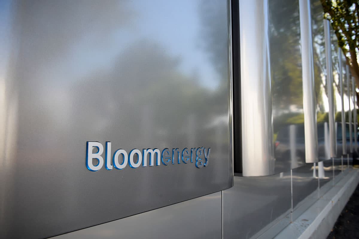 Close-up of a Bloom Energy fuel-cell server enclosure with the Bloom Energy name on its stainless-steel panel