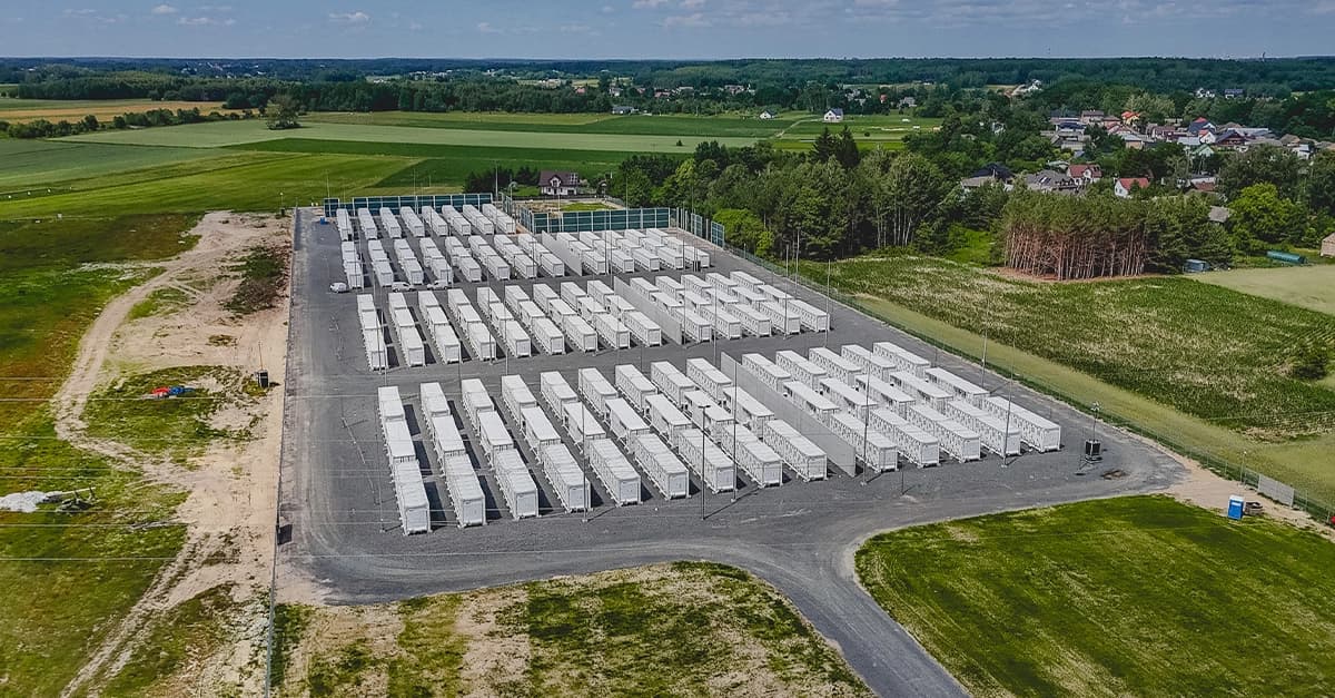Aerial view of rows of white battery storage containers at a Greenvolt Power site in Poland