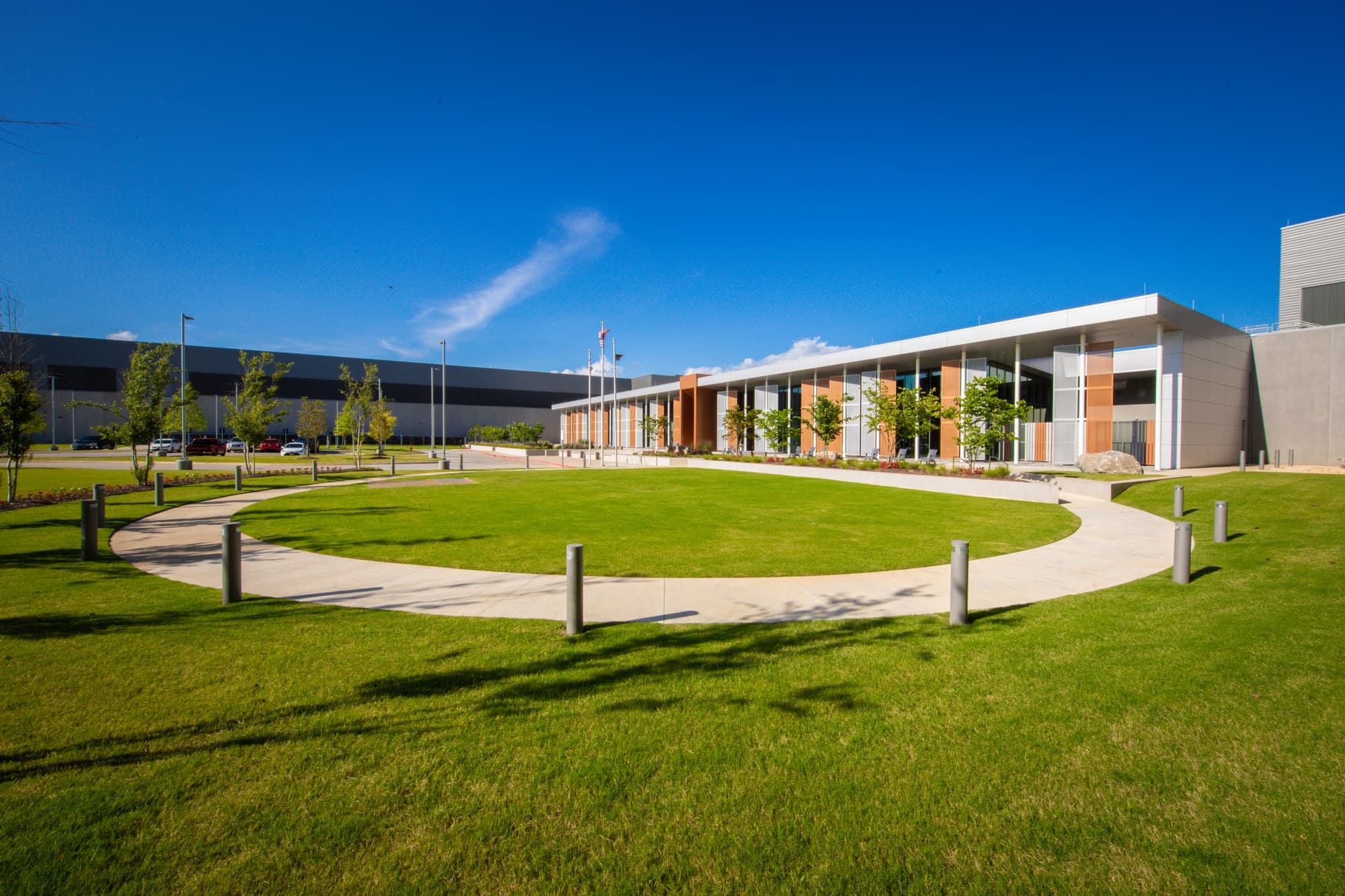 Exterior of Meta's Huntsville data center in Alabama, with an office entrance, lawn and a large data hall behind