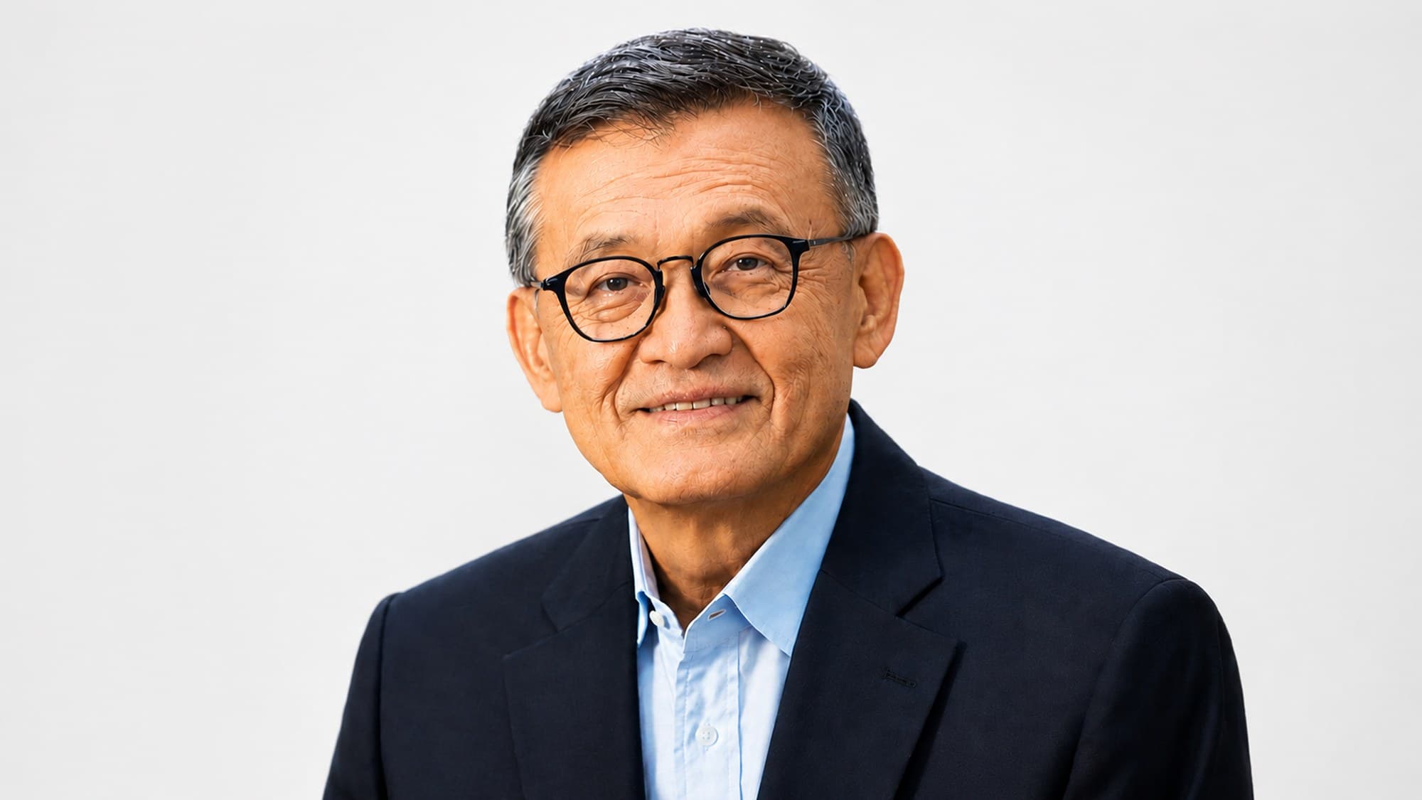 Intel CEO Lip-Bu Tan in a dark blazer and light blue shirt, official portrait from the Intel newsroom