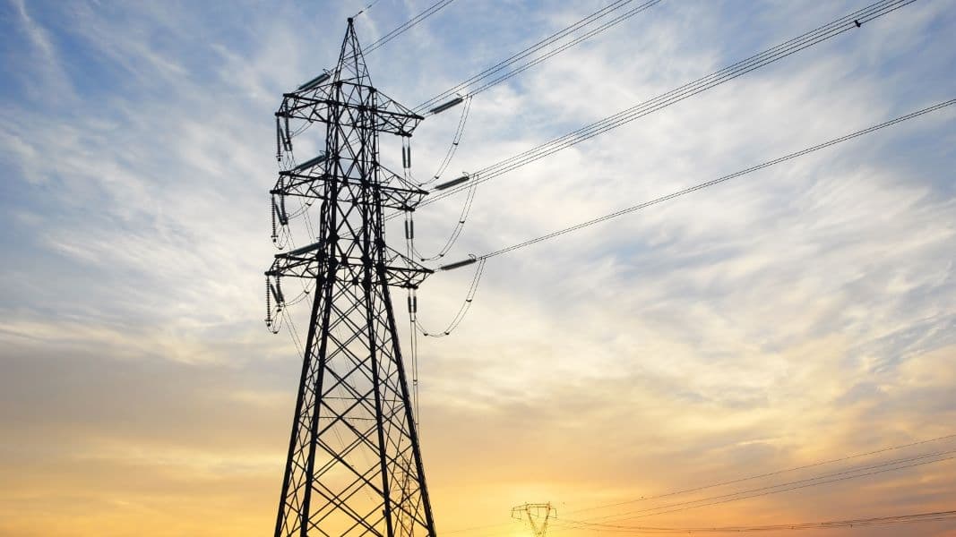 Steel transmission tower and power lines against a sunset sky, from the US Department of Energy grid resilience program page